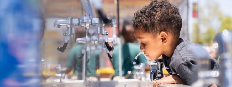 Boy dinking from water fountain